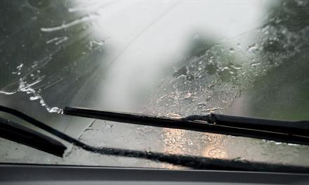 forgetting-replace-wiper-blades windshield wipers clearing away rain from windshield
